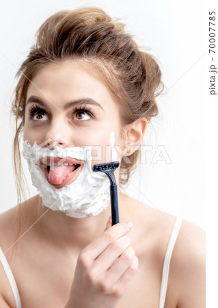 Woman shaving her face by razor Woman shaving her face by razor 70007785