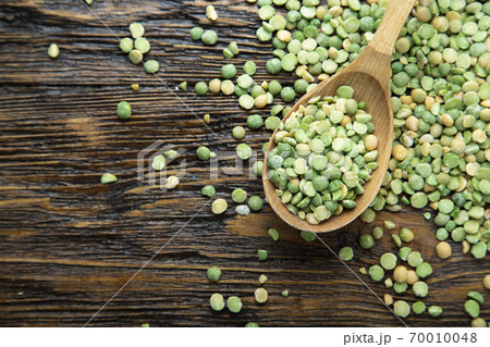 Homemade green peas in a wooden spoon on a wooden surface. Homemade green peas in a wooden spoon on a wooden surface. 70010048