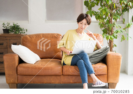 ソファーでワーケーションする女性 70010285