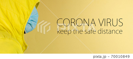 man in yellow jacket is using a protective mask against corona virus on yellow background man in yellow jacket is using a protective mask against corona virus on yellow background 70010849