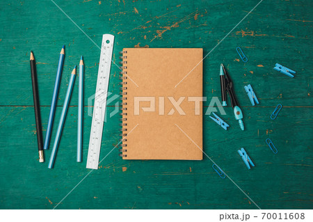 book, pencil, ruler on the green wood study table. book, pencil, ruler on the green wood study table. 70011608