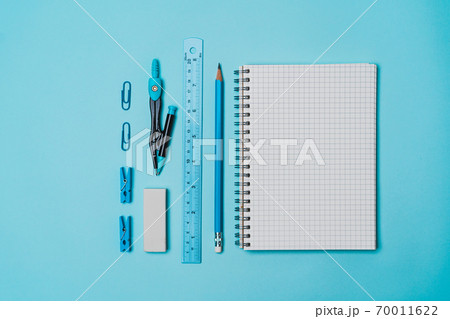 book, pencil, ruler on a blue background. book, pencil, ruler on a blue background. 70011622