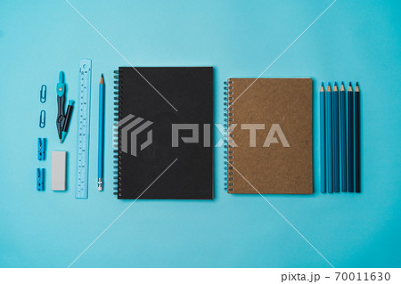 book, pencil, ruler on a blue background. book, pencil, ruler on a blue background. 70011630