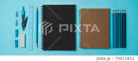 book, pencil, ruler on a blue background. 70011631