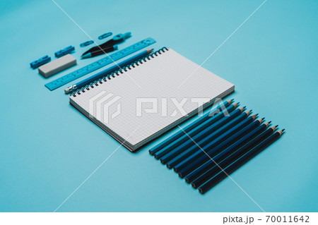 book, pencil, ruler on a blue background. book, pencil, ruler on a blue background. 70011642