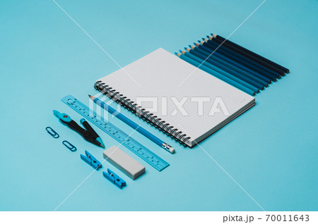 book, pencil, ruler on a blue background. book, pencil, ruler on a blue background. 70011643
