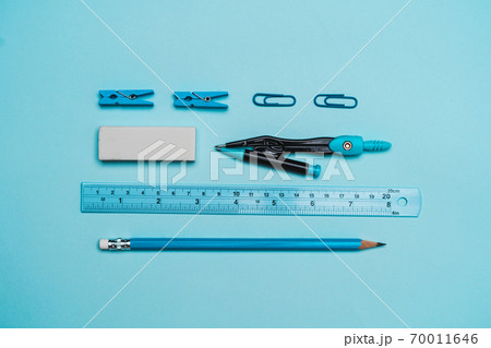 book, pencil, ruler on a blue background. 70011646