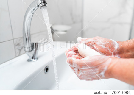 Personal hygiene, cleaning hands with soap often on faucet to protect from virus. Personal hygiene, cleaning hands with soap often on faucet to protect from virus. 70013006