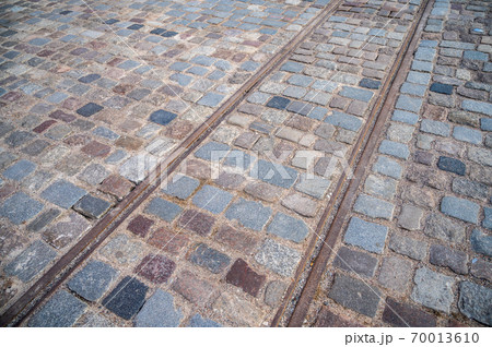 Background square of pavers with old rusty tram rails Background square of pavers with old rusty tram rails 70013610