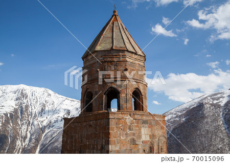 Trinity Church of Gergeti is under cloudy sky. Georgia 70015096
