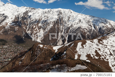 View of Stepantsminda town at sunny spring day View of Stepantsminda town at sunny spring day 70015101