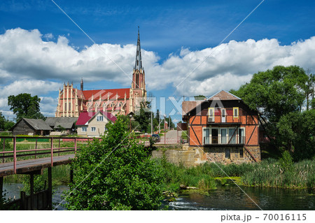 Retro water mill and old church of the Holy Trinity in Gerviaty on background, Grodno region, Belarus 70016115