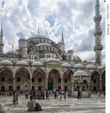 Sultan Ahmed Mosque (The blue Mosque) in Istanbul, Turkey daylight view from inner courtyard with clouds in sky in background 70017281