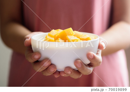 Pumpkin in sweet coconut milk holding by hand 70019899