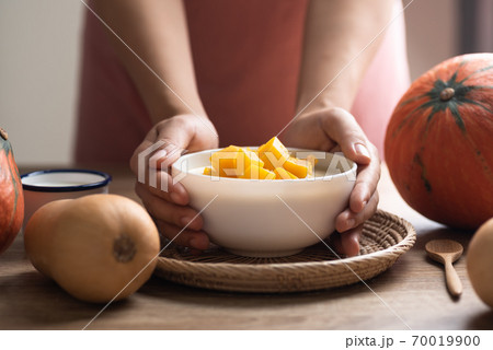 Pumpkin in sweet coconut milk holding by hand 70019900