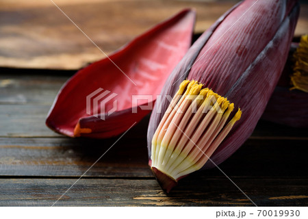 Banana blossom on wooden background, Edible plant in Southeast Asian cuisine Banana blossom on wooden background, Edible plant in Southeast Asian cuisine 70019930