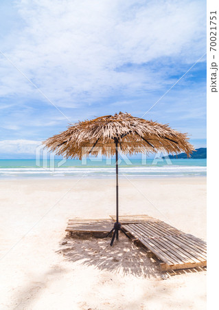 Beach Umbrella made of palm leafs on a perfect white beach in front of Sea in Thailand. Beach Umbrella made of palm leafs on a perfect white beach in front of Sea in Thailand. 70021751