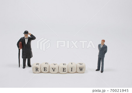 a word REVIEW on wooden cube block with figure a word REVIEW on wooden cube block with figure 70021945