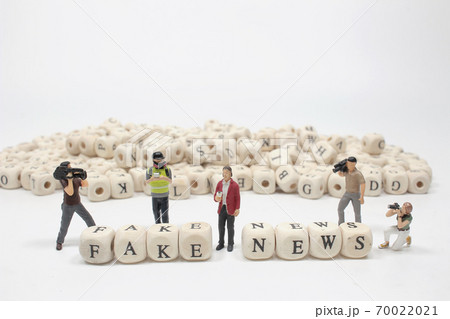 a word fake new on wooden cube block with figure a word fake new on wooden cube block with figure 70022021