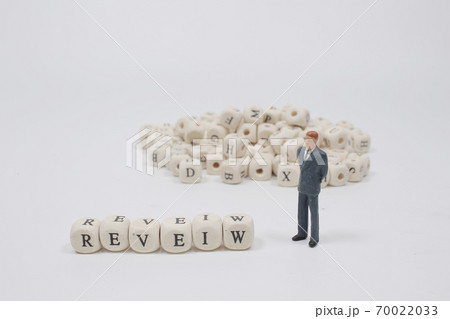 a word REVIEW on wooden cube block with figure a word REVIEW on wooden cube block with figure 70022033