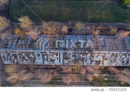 Abandoned derelict industrial greenhouse ruins in autumn, aerial 70025105