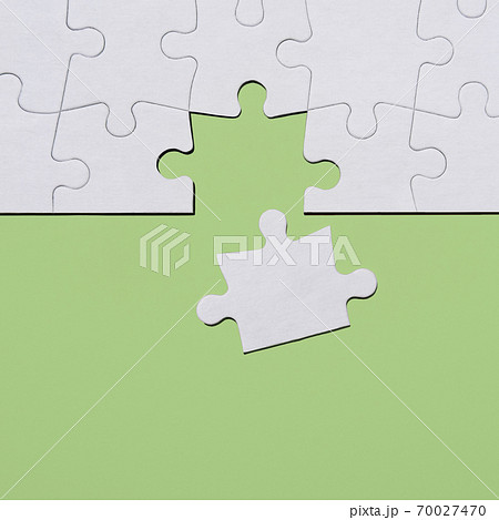 Last puzzle piece in jigsaw puzzle on green background 70027470