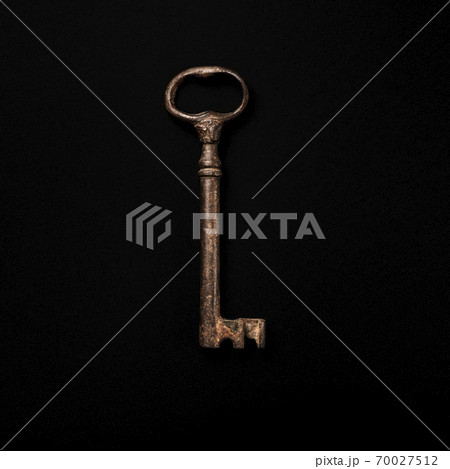 Antique key on black background 70027512