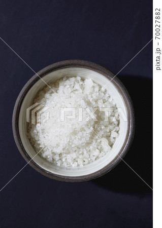Sea salt in bowl on blue background 70027882