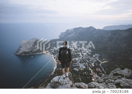 Italy, Liguria, La Spezia, Man looking at mountain range from mountain top Italy, Liguria, La Spezia, Man looking at mountain range from mountain top 70028186
