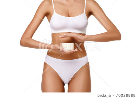 Beautiful Young Woman holding can of cream isolated on white background - Youth and Skin Care Concept 70028989