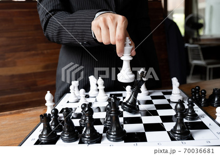 Business women holding king chess on board with white background, challenges planning business strategy to success concept Business women holding king chess on board with white background, challenges planning business strategy to success concept 70036681