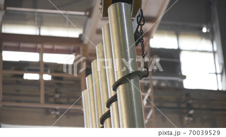 Forming aluminum pillar after melting in modern factory. Production of aluminium metal profiles, commonly used as material in construction and manufacturing. Forming aluminum pillar after melting in modern factory. Production of aluminium metal profiles, commonly used as material in construction and manufacturing. 70039529