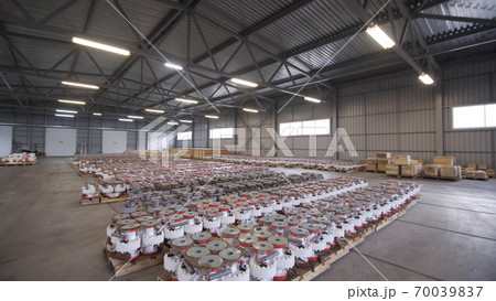 Oil and Gas Wellhead tree equipment production plant in warehouse. Parts of wellhead fittings and butterfly valves. Equipment for wellhead conncetion of oil and gas wells in warehouse. 70039837