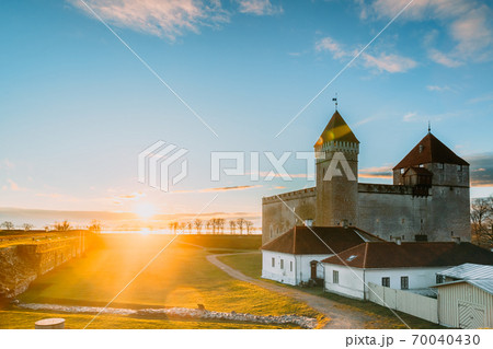 Kuressaare, Saaremaa Island, Western Estonia. Episcopal Castle In Sunset Lights. Traditional Medieval Architecture, Famous Attraction Landmark 70040430