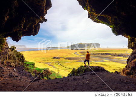 Hiker in the Loftsalahellir Cave near the village of Vik in Iceland 70043562