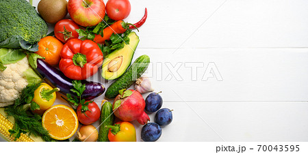 Various vegetables and fruits on the white wooden table, directly above, copy space. Various vegetables and fruits on the white wooden table, directly above, copy space. 70043595