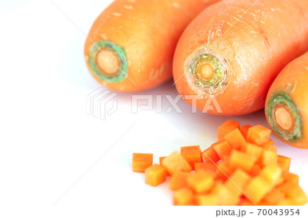 Fresh carrot and cut pieces isolated on white background Fresh carrot and cut pieces isolated on white background 70043954