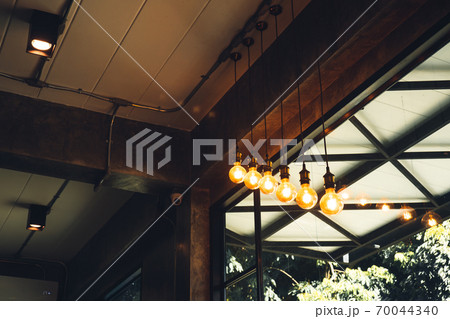 A light bulb in a coffee shop in front of the bar 70044340