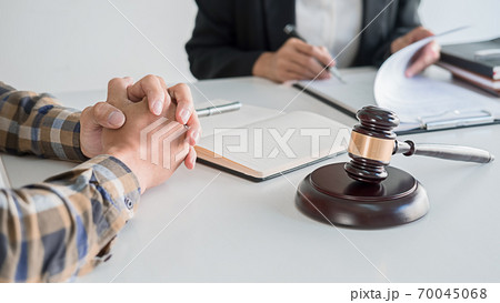 Judge gavel with Justice lawyers having team meeting at law firm background. Concepts of Law and Legal services. Judge gavel with Justice lawyers having team meeting at law firm background. Concepts of Law and Legal services. 70045068