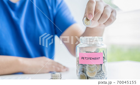 Saving money concept. Close-up of business people hand out coin to stack of coins. Saving money concept. Close-up of business people hand out coin to stack of coins. 70045155