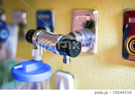 Pressure regulator in a hospital room connected to a connector located on the wall 70046556