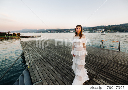Bride in white wedding dress in the old town of Velden am w rthersee.Model in a wedding dress in Austria.Alps 70047305