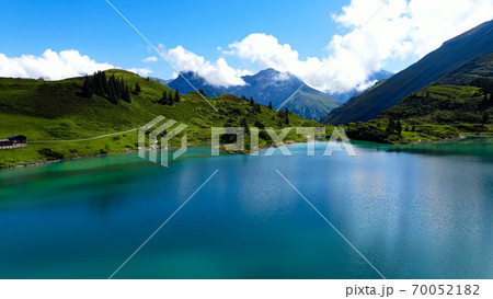 Flight over a wonderful mountain lake in the Swiss Alps - Lake Truebsee on Mount Titlis Flight over a wonderful mountain lake in the Swiss Alps - Lake Truebsee on Mount Titlis 70052182