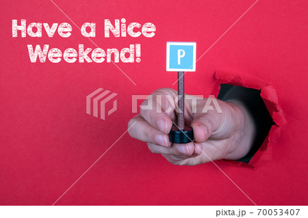 Have a Nice Weekend. Parking road sign in a woman's hand 70053407