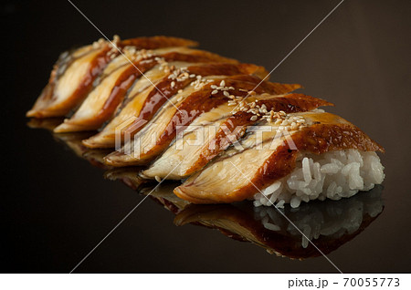 sushi with rice and sesame seeds on a dark background with reflection sushi with rice and sesame seeds on a dark background with reflection 70055773