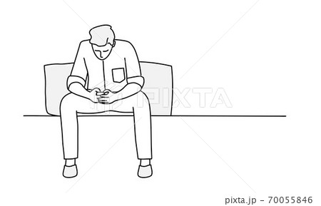 Young man is sitting on sofa and using phone. Young man is sitting on sofa and using phone. 70055846