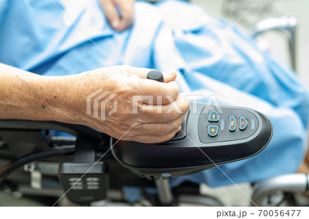Asian senior or elderly old lady woman patient on electric wheelchair with remote control at nursing hospital ward, healthy strong medical concept 70056477