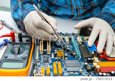 technician repairing inside of hard disk by soldering iron. Integrated Circuit. the concept of data, hardware, technician and technology. technician repairing inside of hard disk by soldering iron. Integrated Circuit. the concept of data, hardware, technician and technology. 70057633