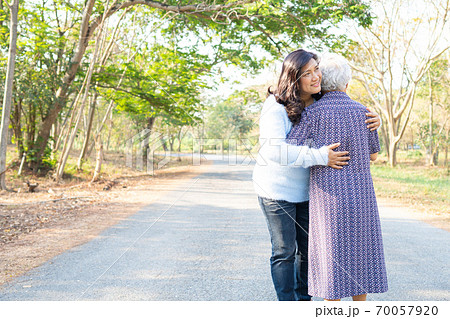 Asian senior or elderly old lady woman hug with her daughter with love, care, help, encourage and empathy at park, healthy strong medical concept Asian senior or elderly old lady woman hug with her daughter with love, care, help, encourage and empathy at park, healthy strong medical concept 70057920