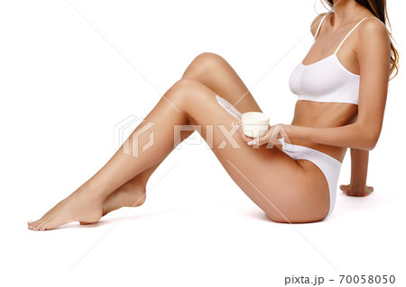 Beautiful Young Woman holding can of cream isolated on white background - Youth and Skin Care Concept 70058050